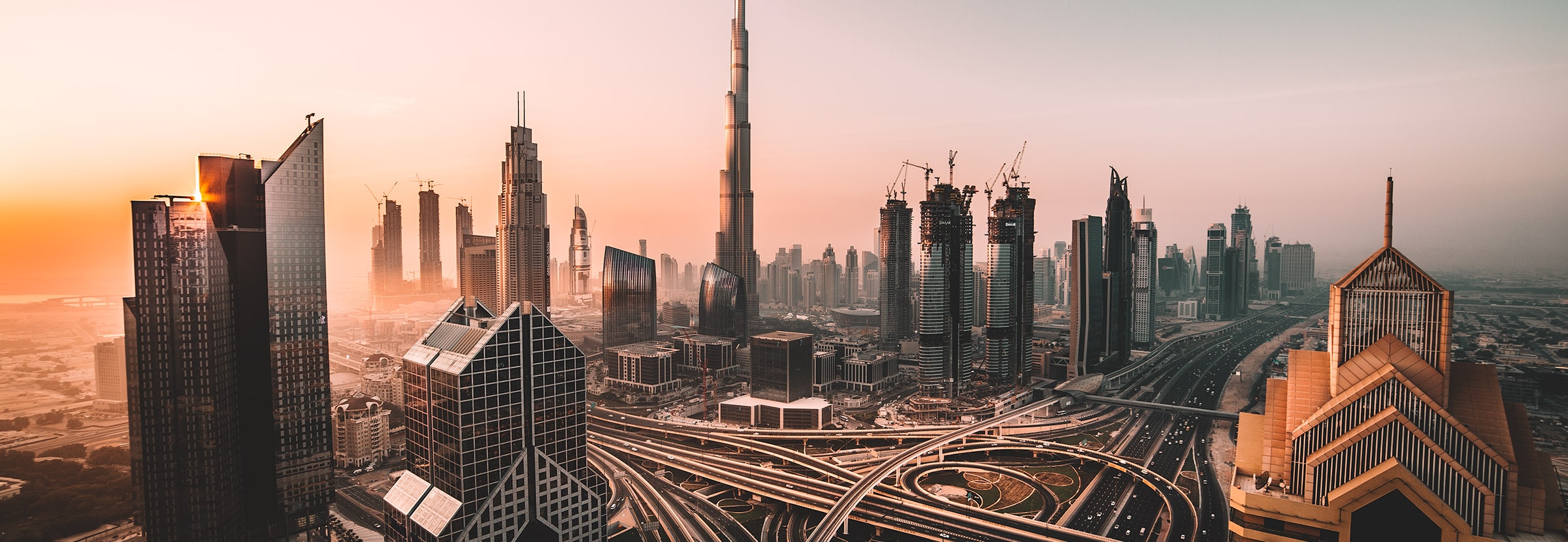 Dubai skyline at sunset with Burj Khalifa and surrounding real estate